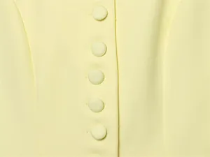 High-quality macro detail of light yellow blazer fabric and fabric-covered buttons
