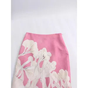 Stylish pink linen blend high-waisted midi skirt featuring large white floral prints.