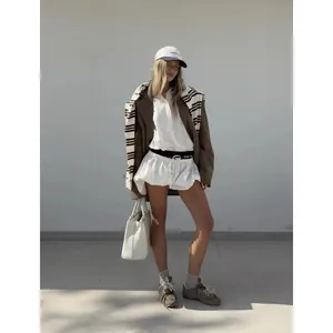 Vintage style white long-sleeve polo shirt for women in a minimalist street style