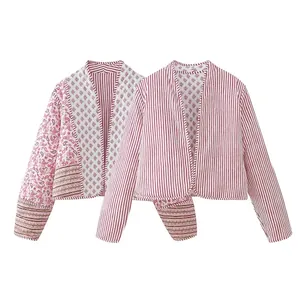 Detailed view of women's reversible quilted jacket featuring paisley and striped patterns