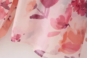 Macro view of the vibrant pink floral print pattern on soft and lightweight chiffon fabric