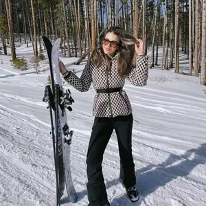 Stylish diamond-patterned hooded ski jacket with waist belt shown in snowy outdoor setting