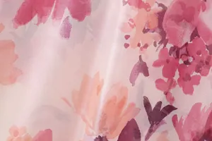 Detailed macro view showing the soft pink watercolor floral pattern on lightweight fabric