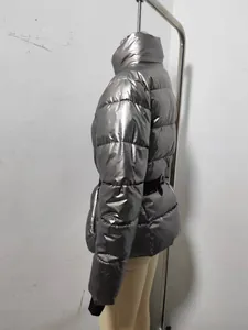 Side profile detail of silver metallic hooded puffer jacket with belt