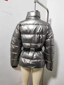Back view of a metallic silver puffer jacket featuring a black belt and cinched waist