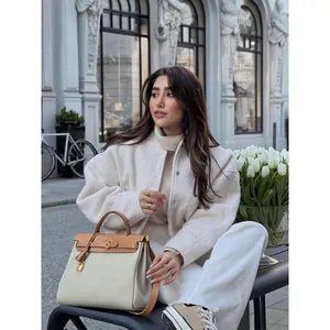 Elegant minimalist stand-up collar beige jacket with large pockets for autumn fashion.