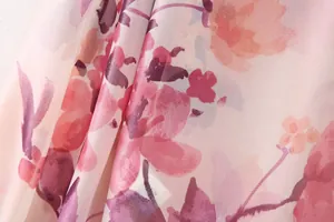 Close-up detail of soft pink floral print fabric on lightweight chiffon dress