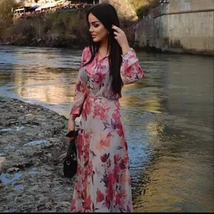 Elegant pink floral print maxi dress with long sleeves and high waist for women.