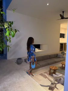 Elegant woman in African style printed mini dress lounging in modern resort patio