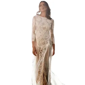 Elegant white lace evening gown featuring long sleeves and intricate hollow-out patterns.