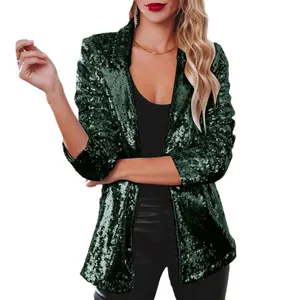 Close-up detail view of dark green sequin blazer showing premium glitter texture and fit