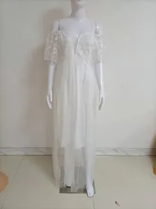 Full display of an elegant white lace wedding gown with sequins on a white mannequin.