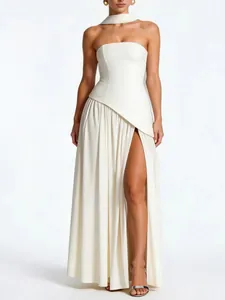 Detail view of an elegant white strapless evening dress with high slit and matching neck ribbon