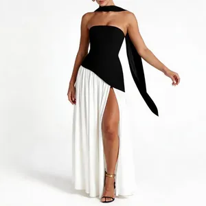 Elegant black and white strapless evening dress with high slit and long ribbon scarf detail.