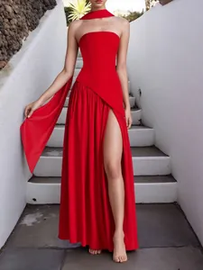 Elegant red strapless evening gown with a high slit and a long flowing neck scarf