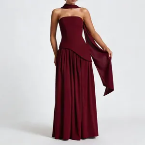 Elegant burgundy strapless evening gown with matching flowing scarf and slim fit silhouette