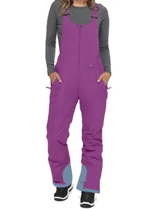 Insulated purple ski bib pants with waterproof fabric and reinforced hems for snow sports