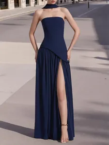 Detail of navy blue strapless evening gown with high slit and matching neck scarf