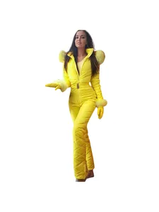 Bright yellow women's waterproof one-piece ski suit with fur hood and matching gloves.