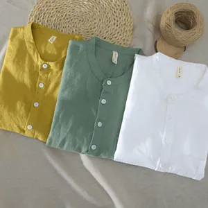 Detailed view of summer breathable cotton linen shirts in yellow, green, and white colors