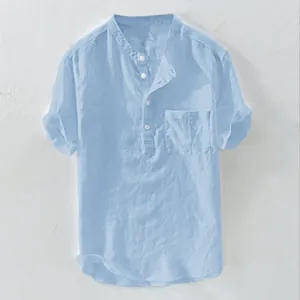 Detail of a light blue short-sleeve linen shirt with Henley collar and chest pocket