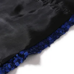 Close-up detail of shiny blue sequins and black satin lining on men's gala blazer