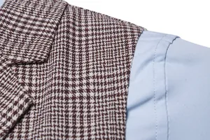 Close-up detail of a men's brown houndstooth waistcoat shoulder and lapel texture