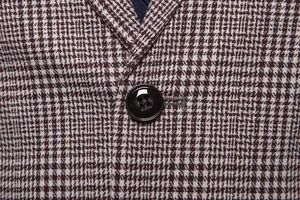 Close-up detail of British style houndstooth plaid fabric and single-breasted button