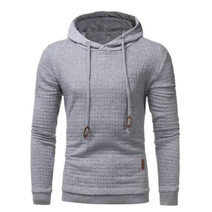 Close-up detail of men's gray quilted hoodie showing diamond lattice fabric texture