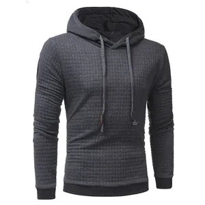 Close-up detail of grey waffle knit texture on men's hooded pullover sweatshirt
