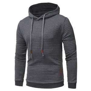 Close-up of men's dark gray hoodie with quilted diamond texture and drawstring details