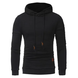 Close-up of men's black hoodie featuring textured diamond quilted pattern and drawstrings