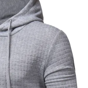 Close-up of grey quilted fabric texture on a casual men's hooded sweatshirt detail