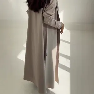 Detailed view of long robe featuring elegant sunflower embroidery on cuffs and hem.