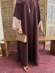 Elegant burgundy long robe featuring printed batwing sleeves and matching brown handbag