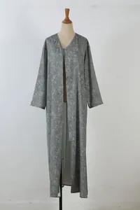 Elegant olive green long-sleeved maxi dress featuring an intricate branch line art pattern