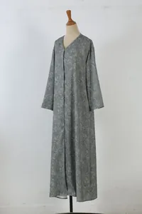 Detail view of an olive green floral print long sleeve maxi dress on a mannequin.