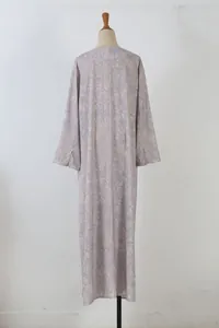 Back view detail of elegant floral long sleeve maxi dress on mannequin