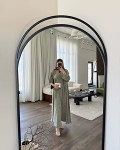 Full-length mirror selfie showing the elegant drape of an olive green commuter maxi dress