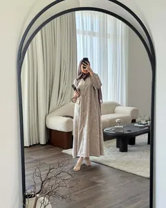 Elegant floral print long sleeve modest dress styled with a hijab in a modern interior.