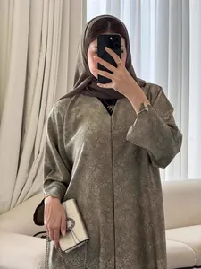 Elegant olive green long dress featuring a subtle floral pattern with a brown hijab