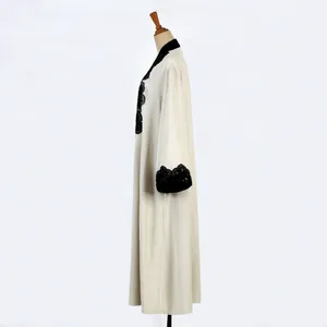 Detailed side view of elegant beige long cardigan robe featuring black lace floral embroidery