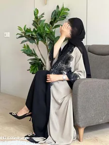 Detail of black lace and sequin floral embroidery on a elegant two-tone abaya robe