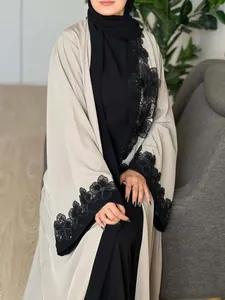 Detail showing elegant black floral lace embroidery on a beige long modest cardigan robe.