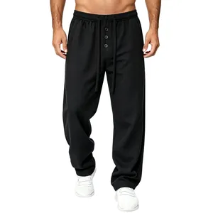 Close-up of men's black waffle-knit casual trousers with adjustable drawstring waist