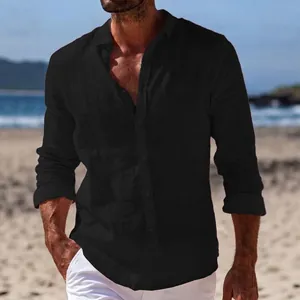Men's casual black long sleeve linen shirt featuring a lapel collar in a beach setting