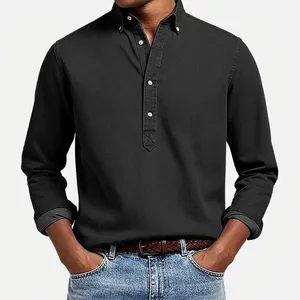 Close-up view of a black textured long-sleeved polo shirt with white buttons for men