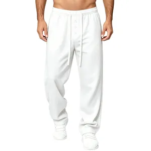 Close-up detail of men's white waffle knit trousers with drawstring and button accents
