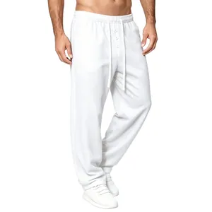 Detail view of men's white waffle knit loose casual pants with drawstring waist.