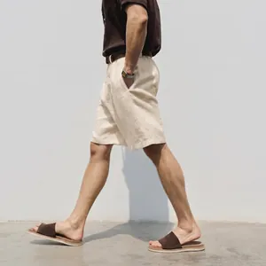 Man walking in breathable beige linen shorts with casual brown sandals